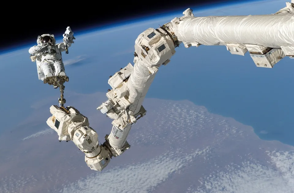 An astronaut works outside the International Space Station