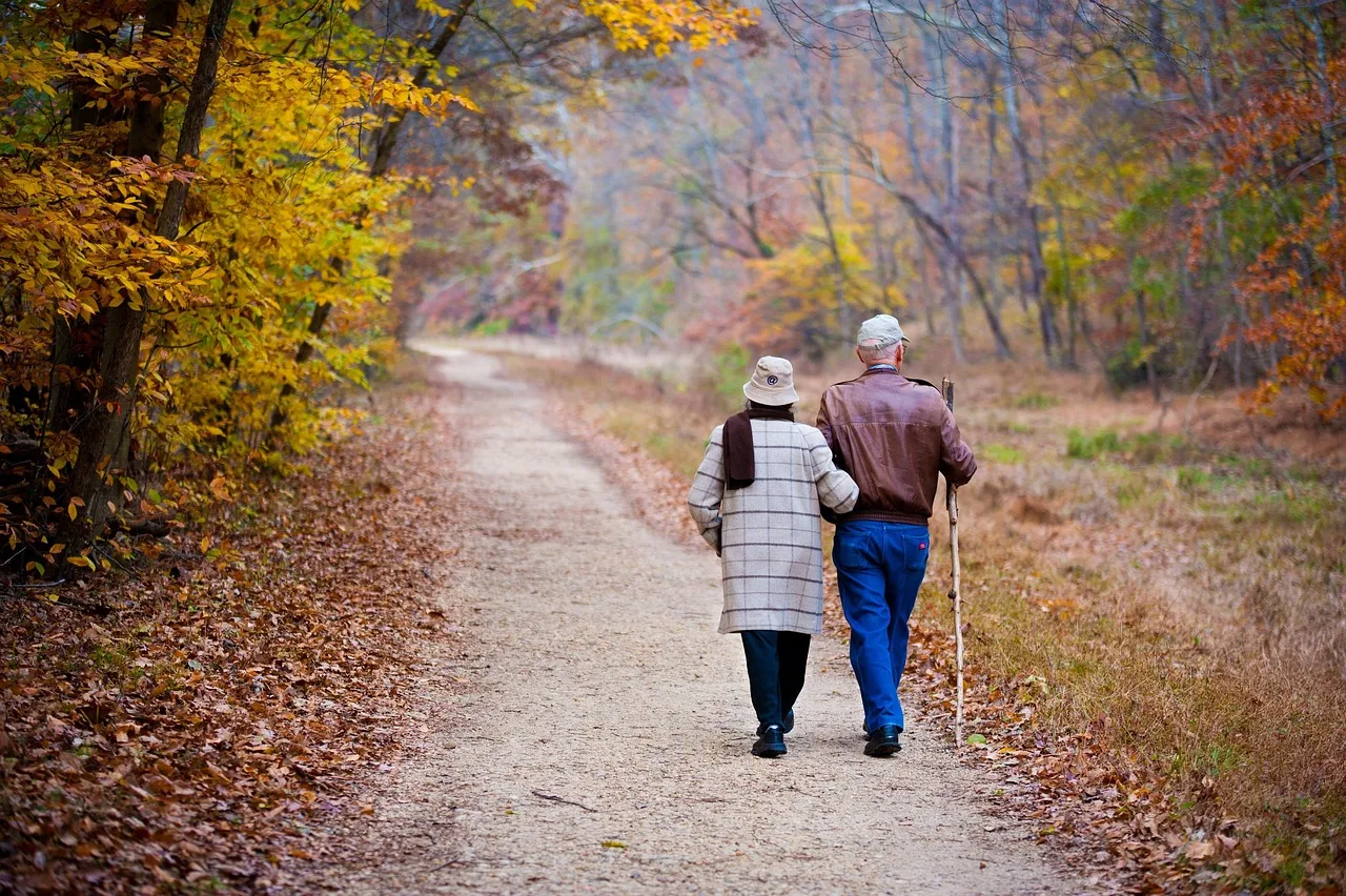 An older couple walking in autumn